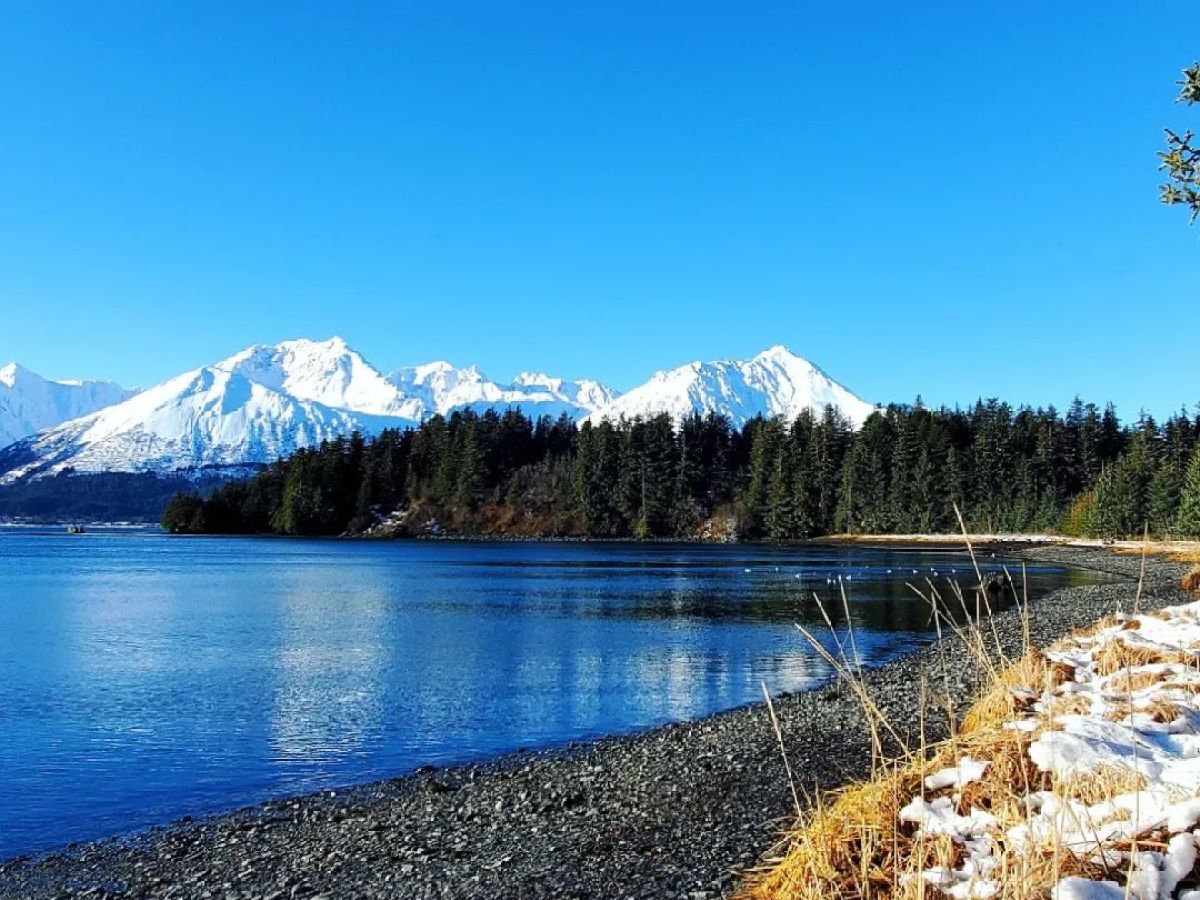 a body of water with a mountain in the background