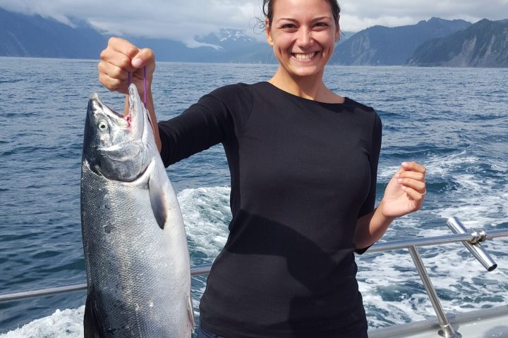 a person holding a fish in the water