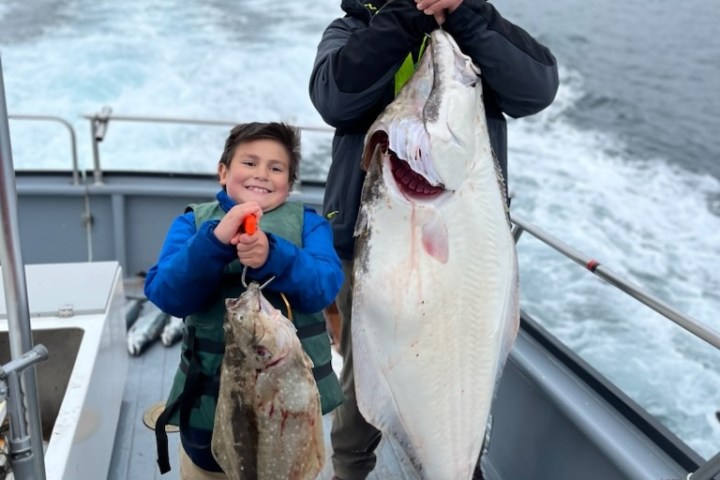 a person holding a fish in the water