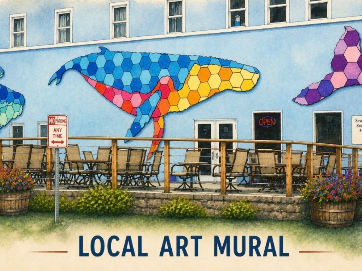 Colorful whale mural on a building with outdoor seating and 'Local Art Mural' text.