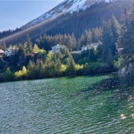 a body of water with a mountain in the background