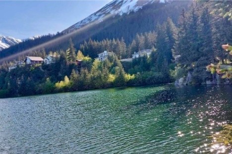 a body of water with a mountain in the background