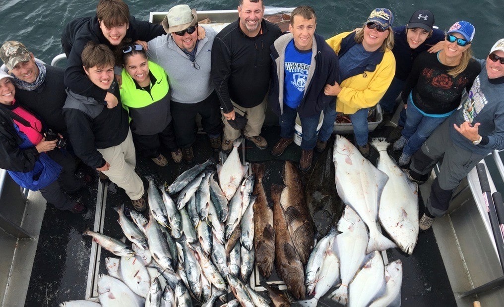 Alaskan-HalibutSalmonRockfish-Fishing-Trip Andrew Lapthorne et al. posing for a fish