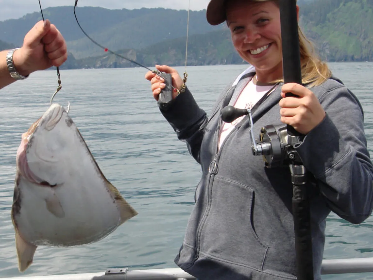 a person holding a fish in the water