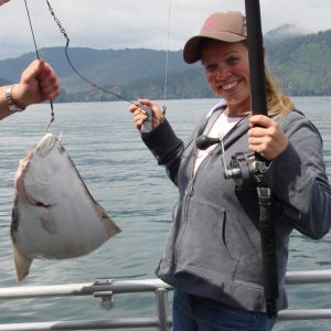 a person holding a fish in the water