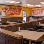 a kitchen with a table in a restaurant