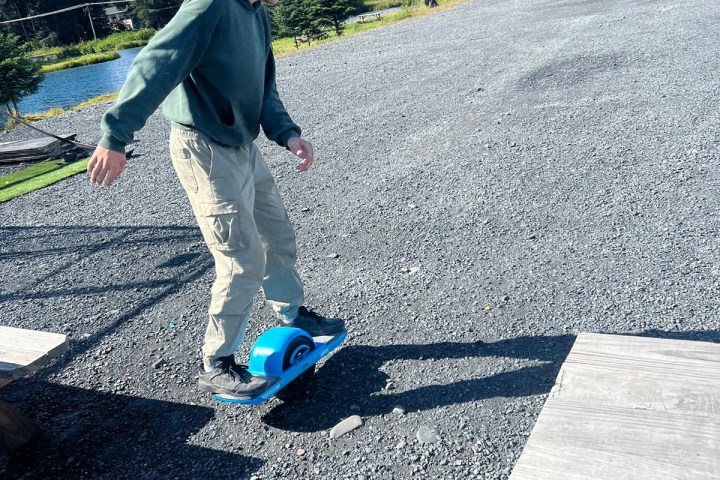 a man riding a skateboard up the side of a road