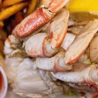 a close up of a sandwich and fries on a plate