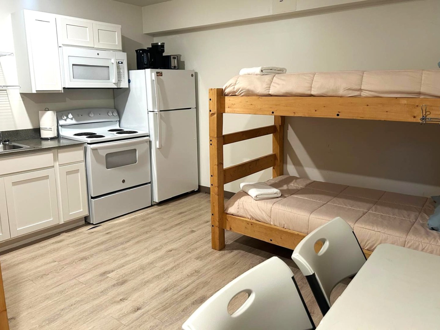 Small kitchen and bunk beds in a compact room.